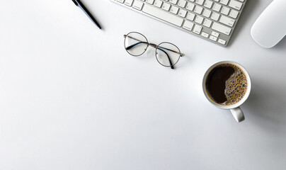 top view of office desk workspace with coffee cup, keyboard and work schedule on white table background. flat lay