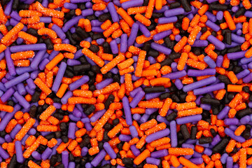 Purple, orange and black candy closeup background