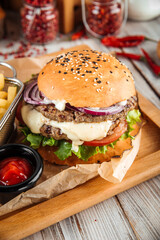 Delicious burger with lamb cutlet and vegetables