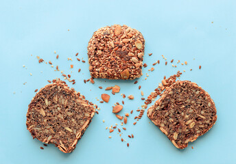 Sliced whole grain bread rye with seeds flax, sunflower, pumpkin and sesame.Healthy food, eco-friendly natural products. Fresh bread on a pink background.
