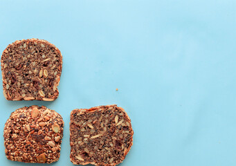 Sliced whole grain bread rye with seeds flax, sunflower, pumpkin and sesame.Healthy food, eco-friendly natural products. Fresh bread on a pink background.