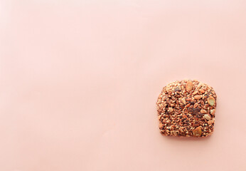 Sliced whole grain bread rye with seeds flax, sunflower, pumpkin and sesame.Healthy food, eco-friendly natural products. Fresh bread on a pink background.