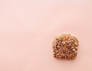 Sliced whole grain bread rye with seeds flax, sunflower, pumpkin and sesame.Healthy food, eco-friendly natural products. Fresh bread on a pink background.