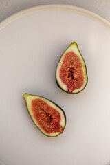 Minimalistic image of figs cut in half.