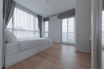 White pillows on wooden bed in minimal bedroom interior