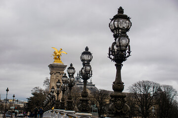 Fototapeta na wymiar Photo of Alexander III bridge in Paris during a cloudy day