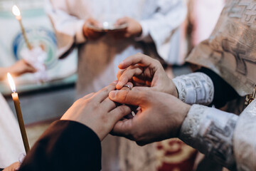 The bride and groom put on each other wedding rings. Wedding ceremony.
