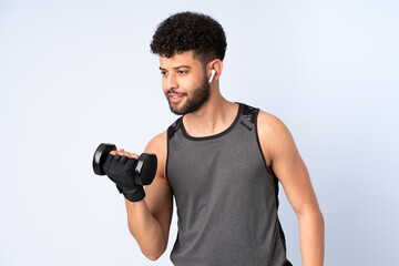 Young Moroccan man isolated on blue background making weightlifting