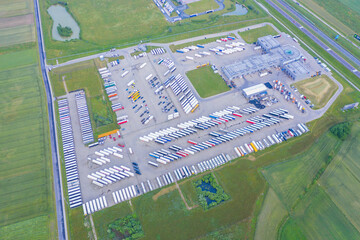 Aerial Top View of White Semi Truck with Cargo Trailer Parking lot.