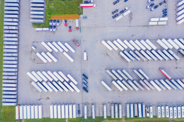 Lots of freight trailers. Cars are in several rows. Truck parking. Aerial view vertically down. © netsay