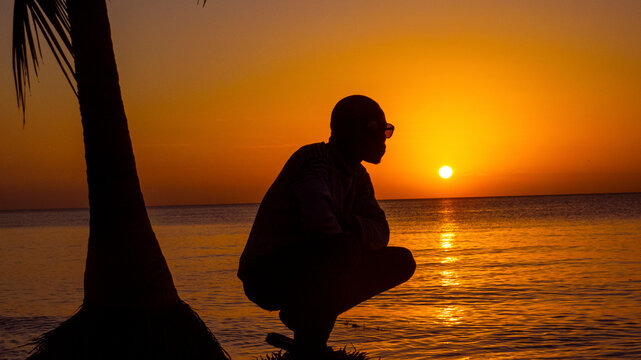 silhouette of a woman on the beach at sunset
