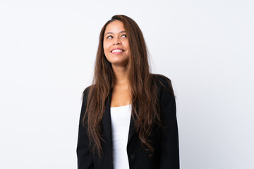 Young Brazilian girl with blazer over isolated white background laughing and looking up