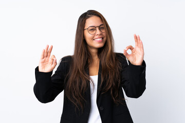 Young Brazilian girl with blazer over isolated white background showing an ok sign with fingers
