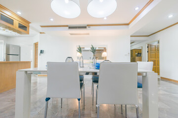 Stylish kitchen interior with dining table and chairs