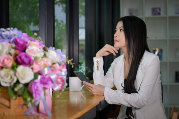 Beautiful businesswoman is talking on a job by calling through Sat to talk to a business with clients, business concepts