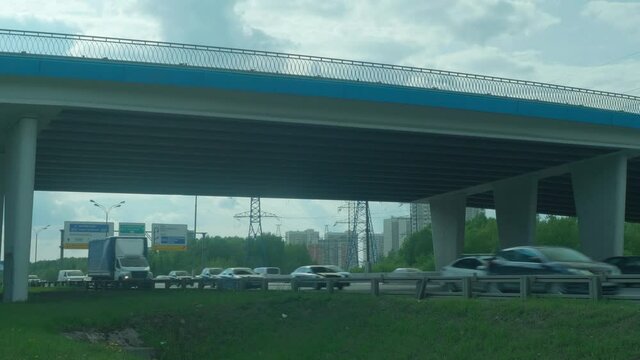 View of traffic on MOscow ring highway MKAD and bridge above it.