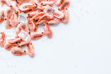 Shrimps - frozen, with ice, at shell - on white backgroud frame copy space