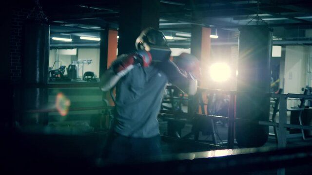 A man in VR-glasses is having a boxing practice