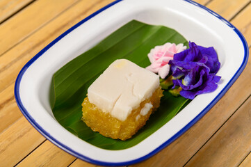 Steamed Cassava Cake with coconut milk on banana leaf, Thai dessert