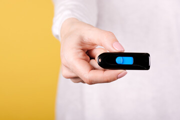 Black usb flash drive in hand.