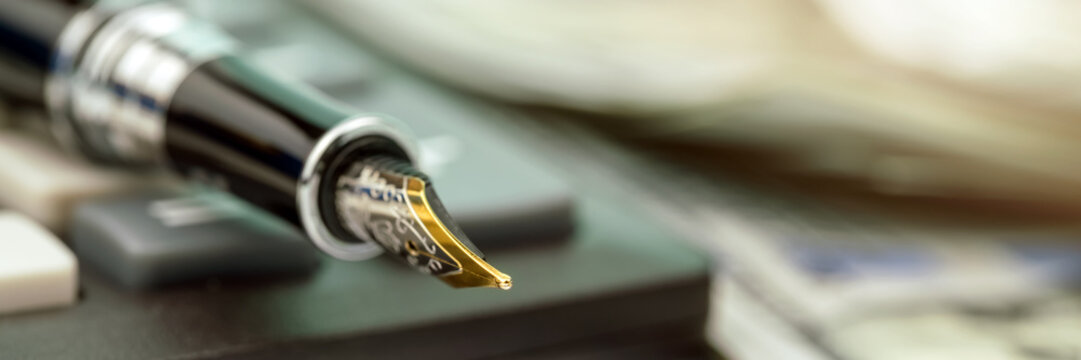 fountain pen golden quill put on calculator edge macro