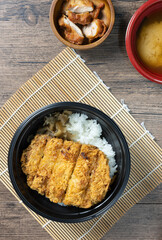 Tonkatsu Curry Rice (Japanese deep-fried pork cutlet with Curry rice) served with karaage (Japanese style fried chicken). top view on wooden background. flat lay.