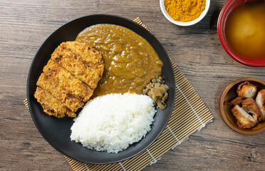 Tonkatsu Curry Rice (Japanese deep-fried pork cutlet with Curry rice) served with karaage (Japanese style fried chicken). top view on wooden background. flat lay.
