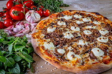 Shimeji mushroom and cream cheese pizza and cooking ingredients: tomatoes, basil, garlic on wood table background.