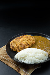 Tonkatsu Curry Rice (Japanese deep-fried pork cutlet with Curry rice). on black background.