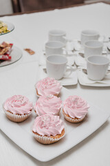 white circles, pink cupcakes, sweet table