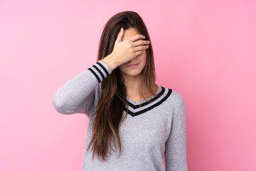Teenager girl over isolated pink background covering eyes by hands