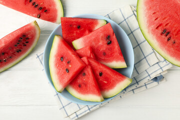 Composition with plate of fresh watermelon on white wooden background, top view
