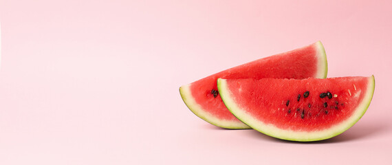 Slices of fresh watermelon on pink background. Summer fruit