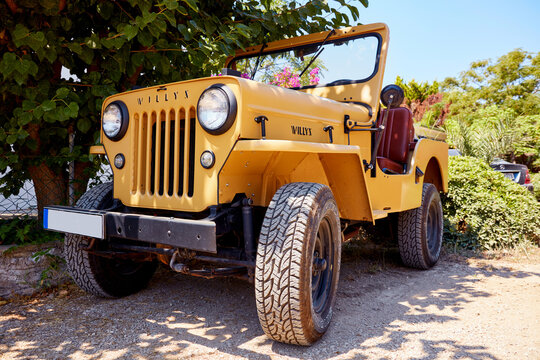 Vintage modified Willy's jeep parked on a dirt road