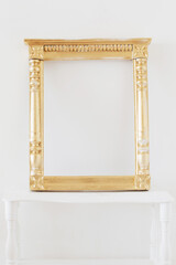 antique golden wooden frame on background white wall