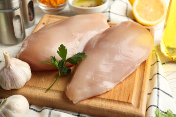 Raw chicken meat and ingredients on wooden background. Cooking chicken