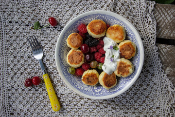 homemade cheesecakes with sour cream and berries - raspberries, cherries, mulberries

