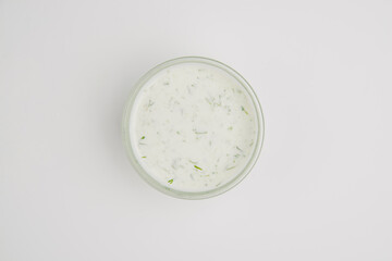 Mayonnaise with herbs. Mayonnaise sauce. Mayonnaise in a sauceboat on a light background