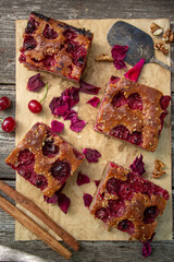 homemade seasonal pie with cherries and nuts. Sliced ​​in square pieces.