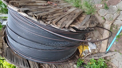 Fiber optic cable image on a large wooden spool. 