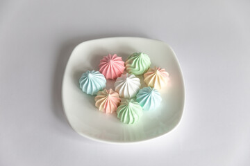 Fototapeta na wymiar meringues on saucer on isolated white background.