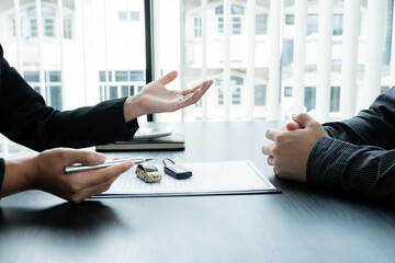 The car dealer advises the customer about insurance details and car rental information Ready...