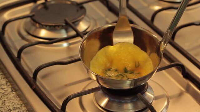 cooking eggs in a ladle and serving a mini omelette