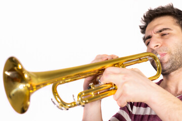Trumpet player, plays the instrument, eyes are half open and blowing / isolated white background