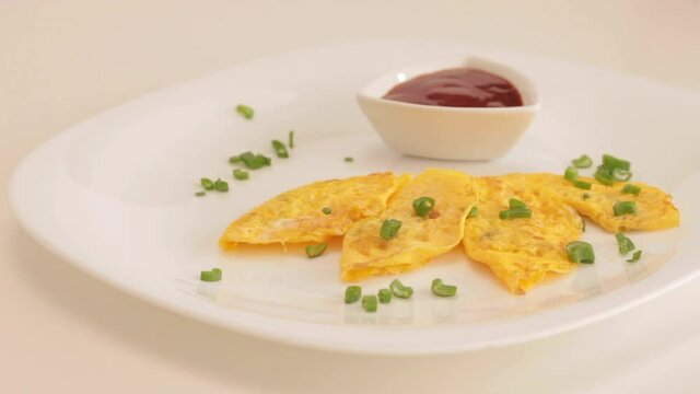 cooking eggs in a ladle and serving a mini omelette
