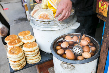 asian street food boiled eggs in a hot pot and fired pancake 