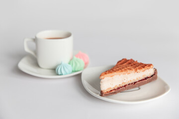 meringues, cake, sweets and a cup of coffee on a white background. Good morning.