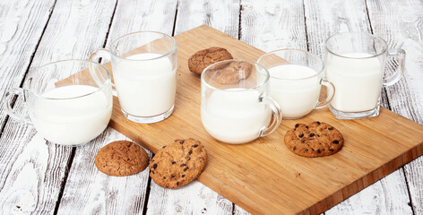 Five cups with milk and cookies
