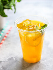 orange juice or lemonade with mint or lemonade with mint  transparent glass cup with mint takeaway drink Menu concept serving size food background top view copy space for text organic healthy eating