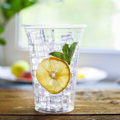 orange juice or lemonade with mint or lemonade with mint  transparent glass cup with mint takeaway drink Menu concept serving size food background top view copy space for text organic healthy eating
